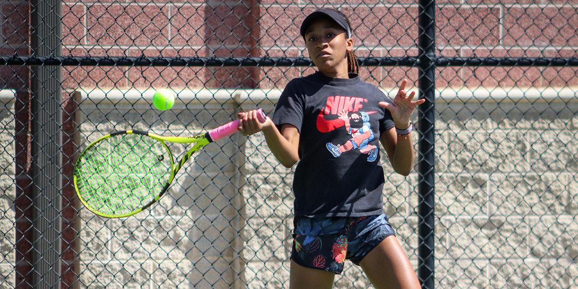 young girl playing tennis