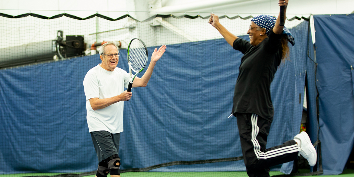 Two men celebrating on a tennis court